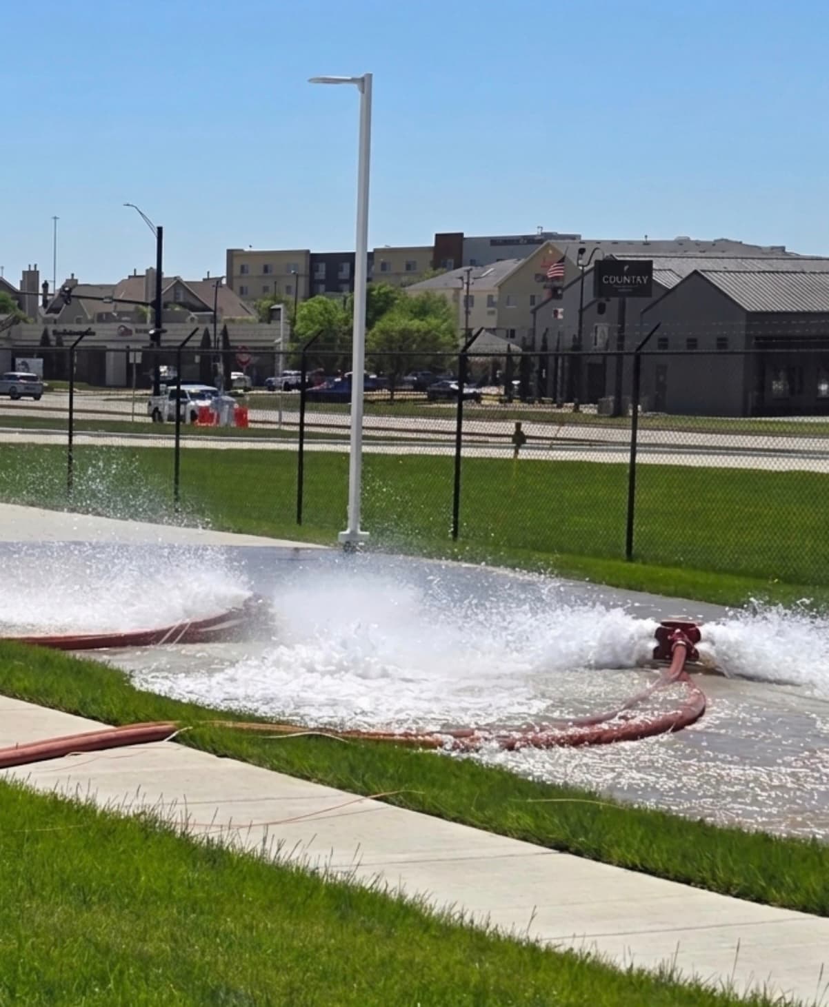 Water discharging from test hoses during a Myers AFP full-flow fire pump performance test at a Kansas commercial property