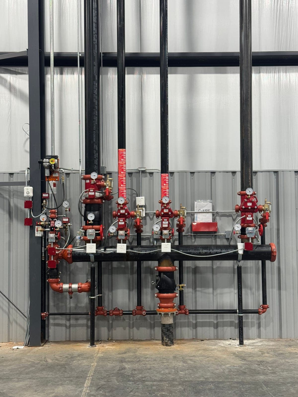 Fire sprinkler riser manifold with control valves and gauges inspected at a Kansas commercial facility